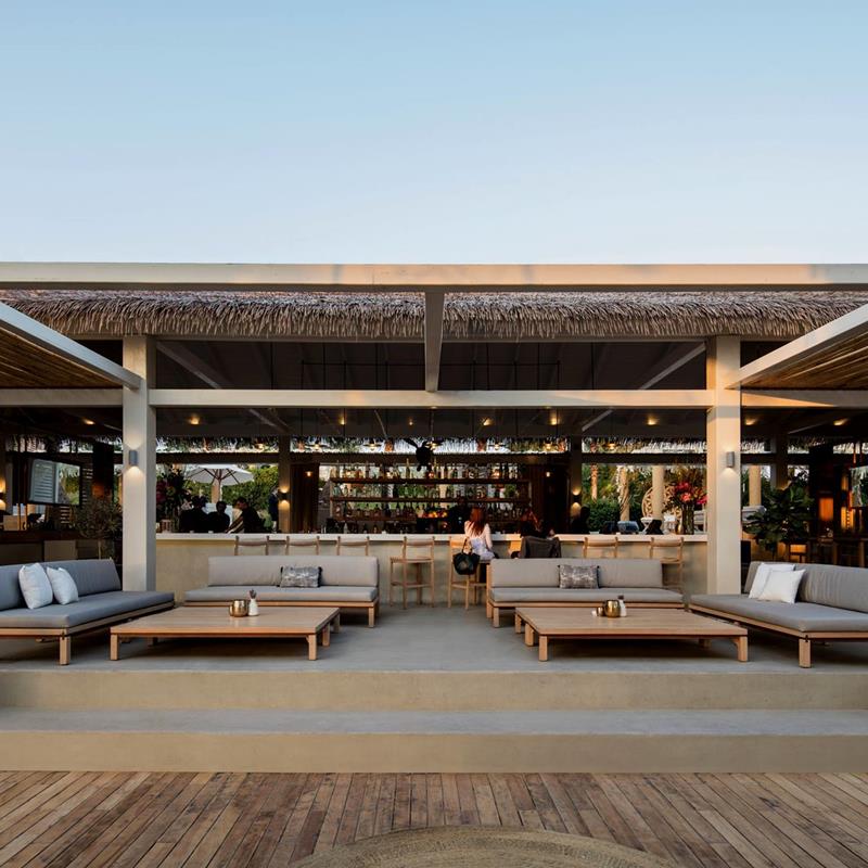 Éclairage extérieur uniforme et chaleureux sous pergola, mise en valeur des poteaux et des zones d’assise